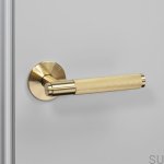 3.-BusterPunch_Door_Handle_Left_Fixed_Brass-scaled.jpg