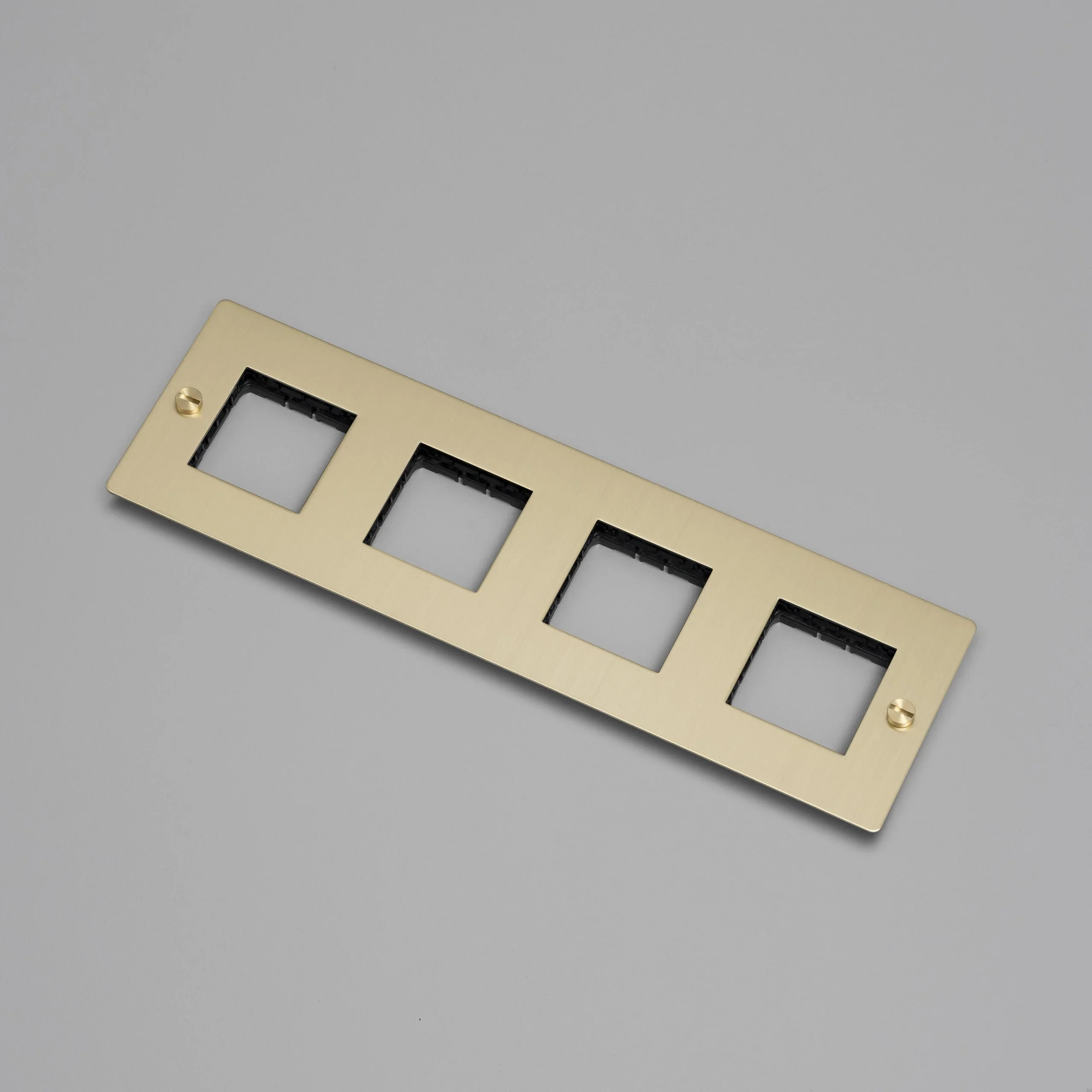 EU_ELECTRICITY_4G_Wall_Plate_No_Infill_Brass_Web-scaled.webp